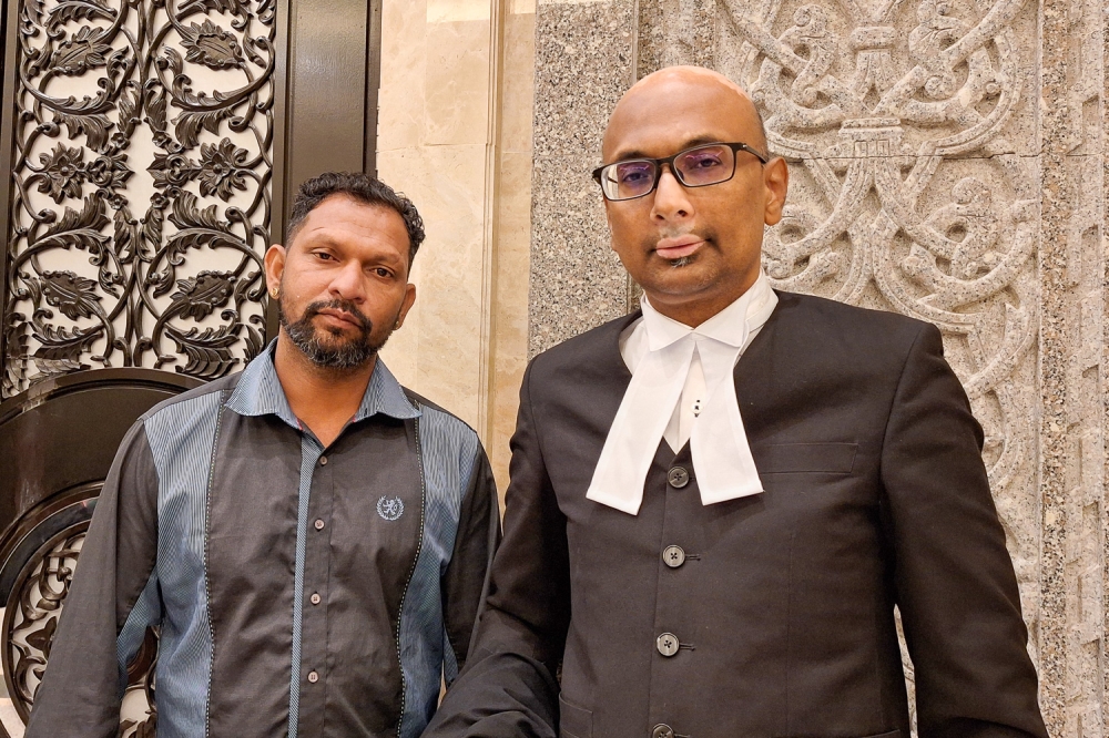 Perak-born man Velmurugan (left) and his lawyer Annou Xavier are seen here for Velmurugan's citizenship case at the Court of Appeal at the Palace of Justice, Putrajaya, today. — Picture by Ida Lim