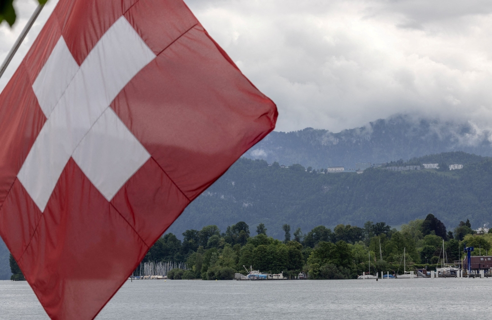 A Swiss flag stands in front of the Bürgenstock Resort, the venue for the Summit on Peace in Ukraine, near Lucerne on May 28, 2024. — Reuters pic