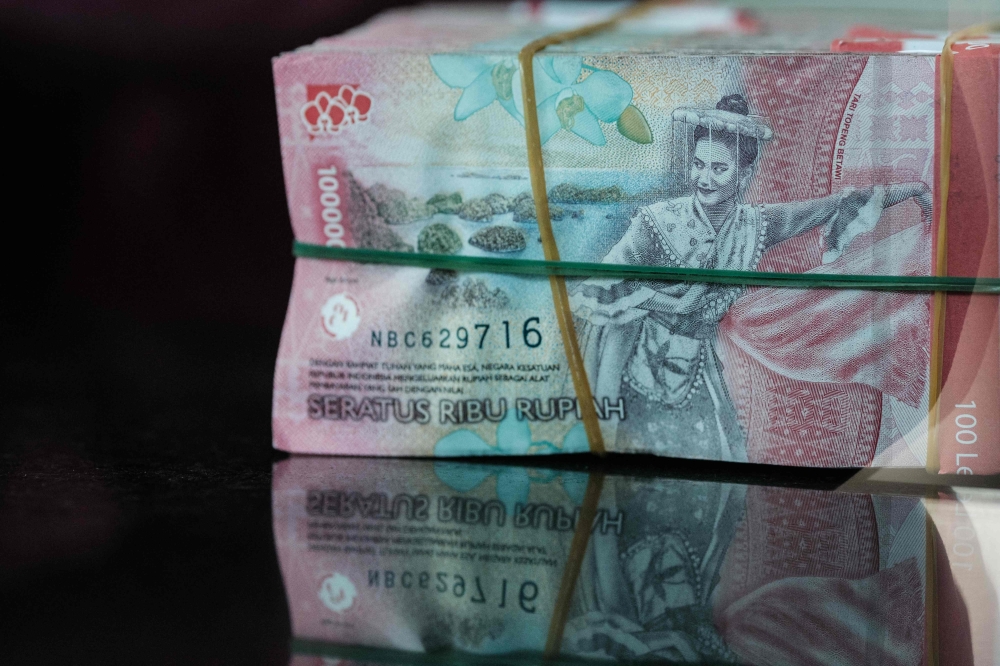 Bundles of Indonesian rupiah banknotes are pictured at a currency exchange office in Jakarta on June 4, 2026, after the rupiah weakened beyond 18,000 per US dollar for the first time. — AFP pic 