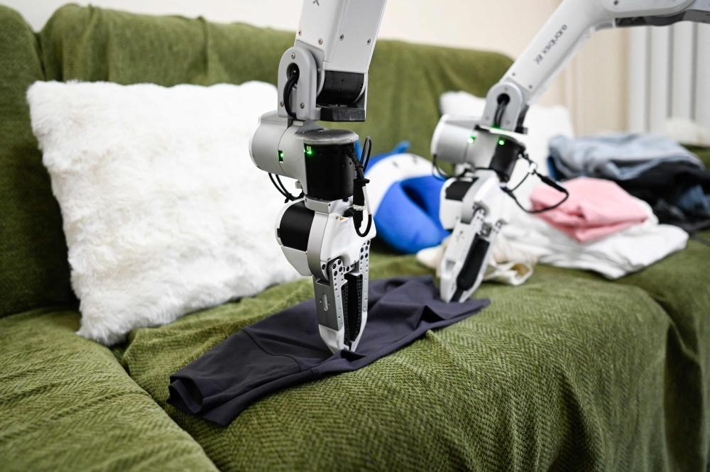 This picture taken on May 21, 2026 shows an X Square Robot folding clothes a customer’s home in Beijing. — AFP pic 