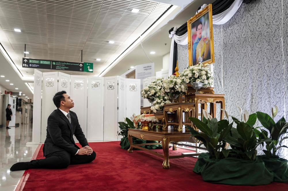 A mourner pays respects in front of a portrait of the late Thai Princess Bajrakitiyabha Mahidol at Chulalongkorn Hospital in Bangkok on June 13, 2026. — AFP pic