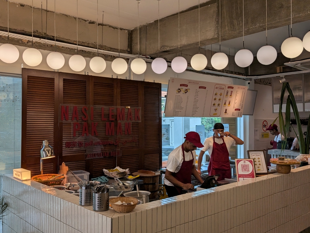 Order at the counter, where all the ‘lauk’ is displayed, and small breakfast items like ‘roti bakar’ are also offered. — Picture by Ethan Lau