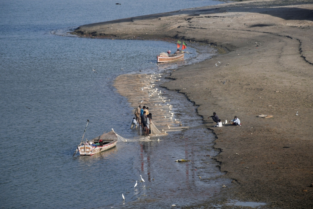 This file picture shows fishermen clear a fishing net on the riverbed of the Indus River in Hyderabad, Pakistan April 25, 2025. — Reuters pic