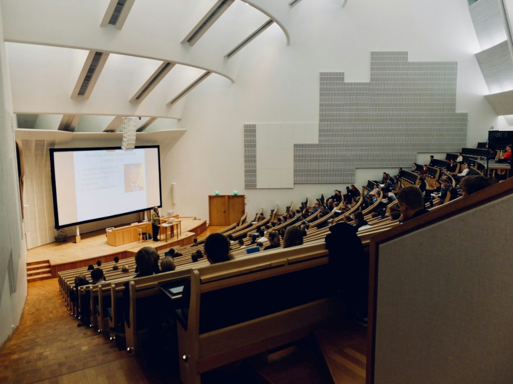 File picture of a lecturer addressing students in a university lecture hall. The commentary argues that an overemphasis on PhD qualifications and publication records in academic hiring may come at the expense of teaching quality. — Unsplash pic