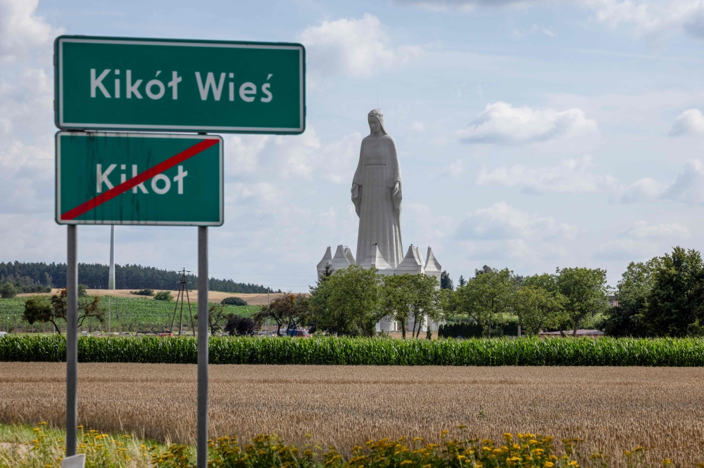 A statue of the Virgin Mary is seen over the road in Konotopie vilage, next to Torun, central Poland on July 22, 2026. At 55 meters high, the concrete and steel beam figure in Konotopie is the tallest Marian statue in Europe, and second in the world. — AFP pic