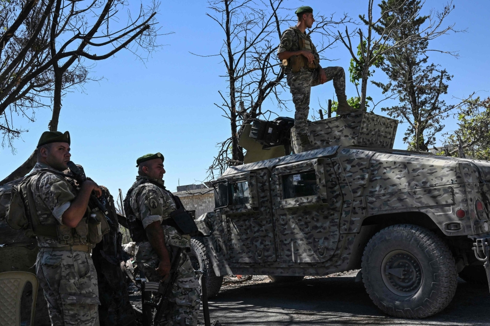 Lebanese soldiers stand guard in Zawtar al-Gharbiya on July 28, 2026, after the army deployed to the southern village last week as part of a framework deal reached with Israel. — AFP pic