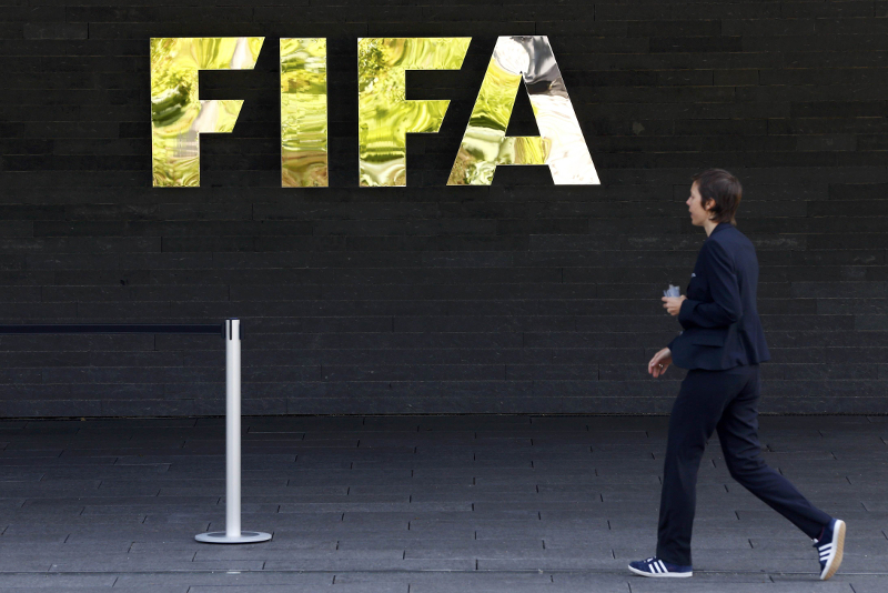 A staff walks past a logo of football's international governing body FIFA at their headquarters in Zurich, Switzerland May 27, 2015. u00e2u20acu201d Reuters pic
