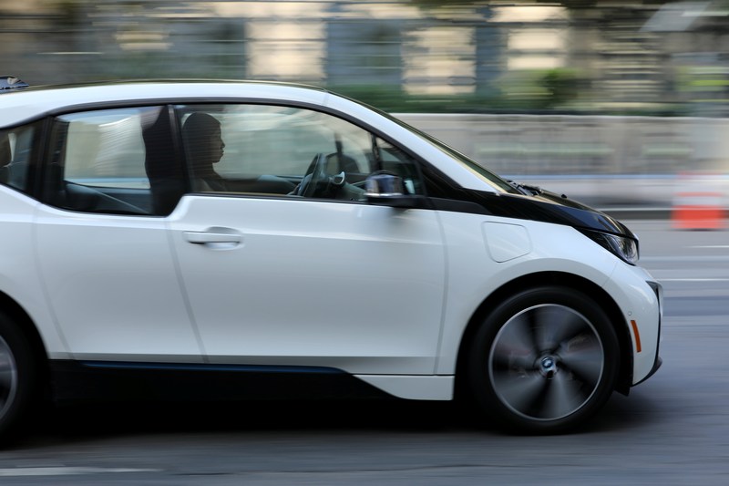 A woman drives an electric BMW i3 vehicle along a downtown street in Los Angeles August 10, 2017. — Reuters pic