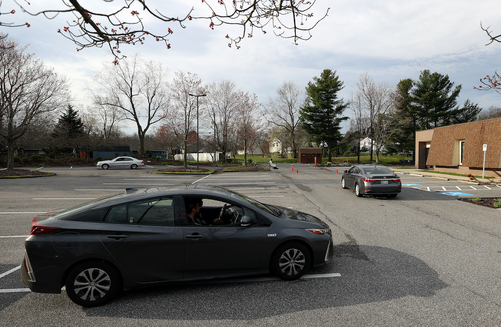 Cars line up as Father Scott Holmer of St. Edward the Confessor Catholic Church holds confession in the church parking lot on March 21, 2020 in Bowie, Maryland. — AFP pic