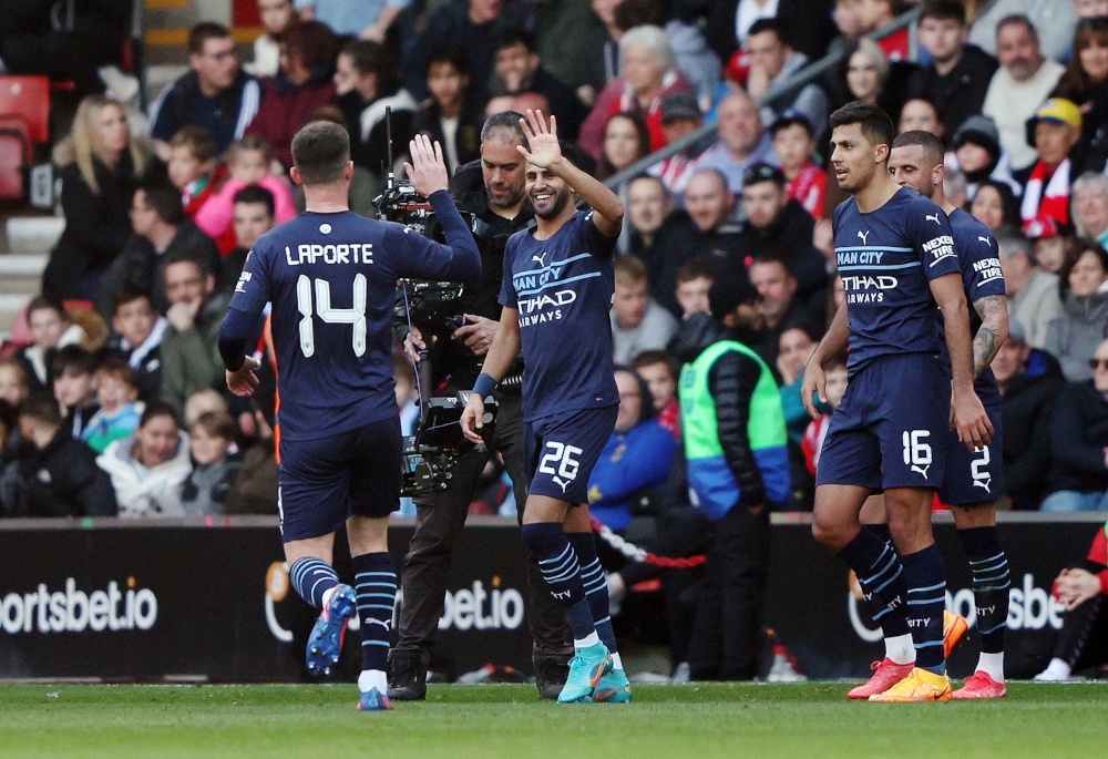 Manchester Cityu00e2u20acu2122s Riyad Mahrez celebrates scoring their fourth goal with Aymeric Laporte at St Maryu00e2u20acu2122s Stadium, Southampton, Britain, March 20, 2022. u00e2u20acu201d Reuters picn