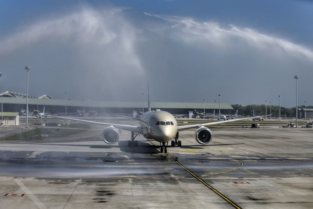 A plane receives a water cannon salute upon arrival at KLIA after Malaysia reopened its borders, April 1, 2022. u00e2u20acu201d Picture by Ahmad Zamzahuri