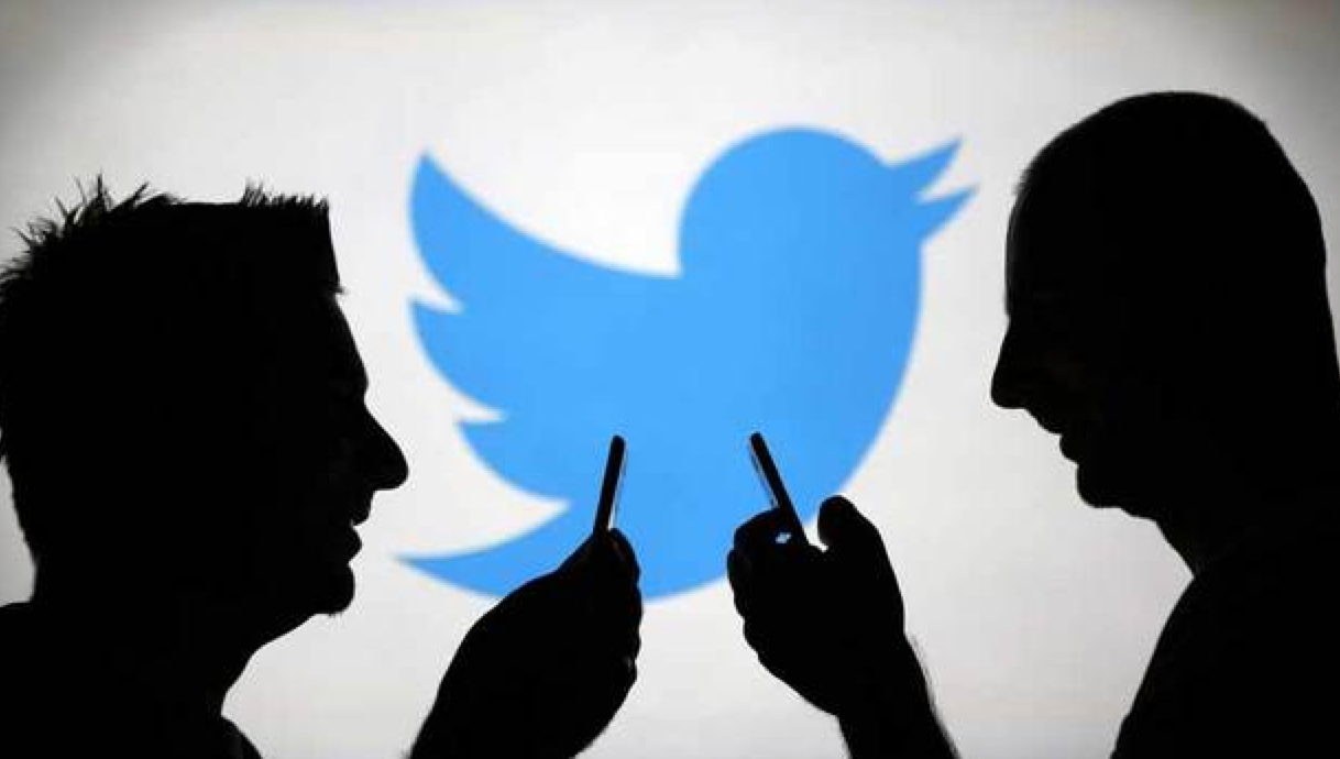 Men are silhouetted against a video screen with a Twitter logo as they pose with Samsung S3 and S4 smartphones in this photo illustration taken in the central Bosnian town of Zenica on August 14, 2013. u00e2u20acu201d Reuters pic