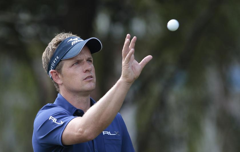 Luke Donald of Britain gets his ball back from his caddy on the fifth hole during the second round of the WGC-HSBC Champions golf tournament in Shanghai November 1, 2013. u00e2u20acu201d Reuters pic